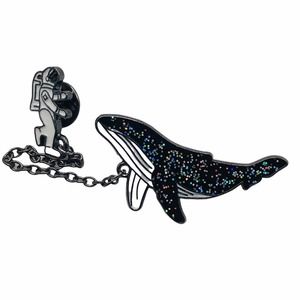 Spaceman and space whale lapel pin, brooch.